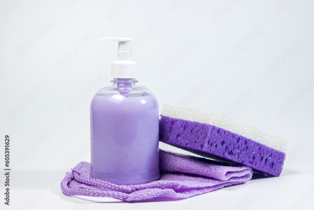 Liquid soap, bath sponge and washcloth on a white background. Hygiene product. Liquid soap, bath sponge and washcloth on a white background. Hygiene product.