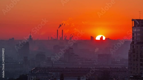 Morning mist and red sky. Residential buildings on Leninskiy avenue, Stalin skyscrapers, smoking pipes and panorama of city at sunrise timelapse in Moscow, Russia. Close up. Aerial view from rooftop photo