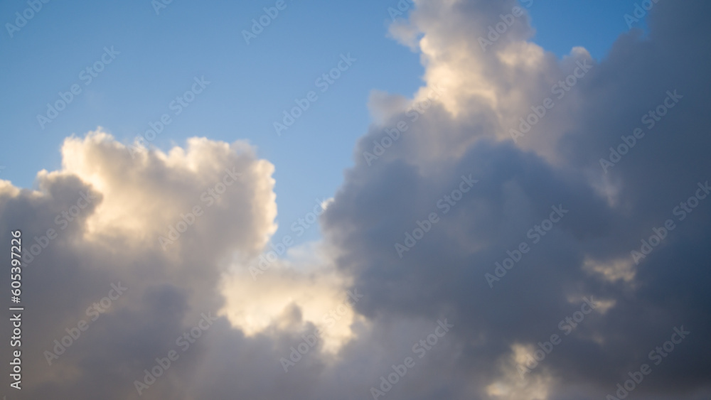 Blue sky background with white clouds. Cumulus white clouds in the sky.