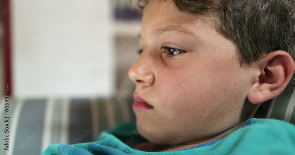 Child boy face staring at tablet screen Child boy face staring at tablet screen
