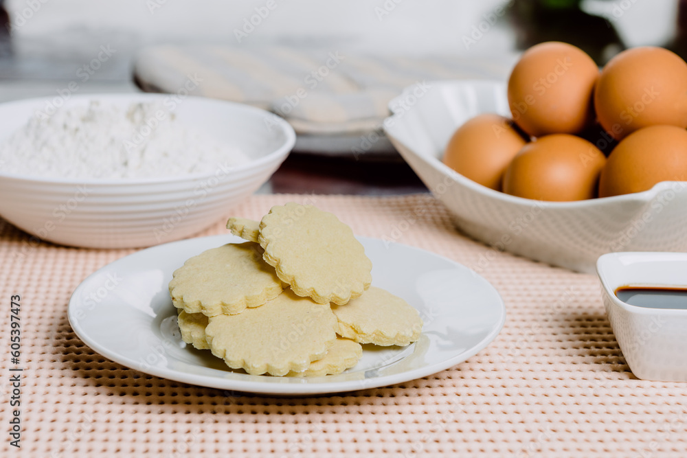 Cookies with ingredients on wooden table. Alfajores with ingredients. Caramel cookie. Cookies with ingredients on wooden table. Alfajores with ingredients. Caramel cookie.