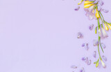 wisteria and freesia flowers on purple background