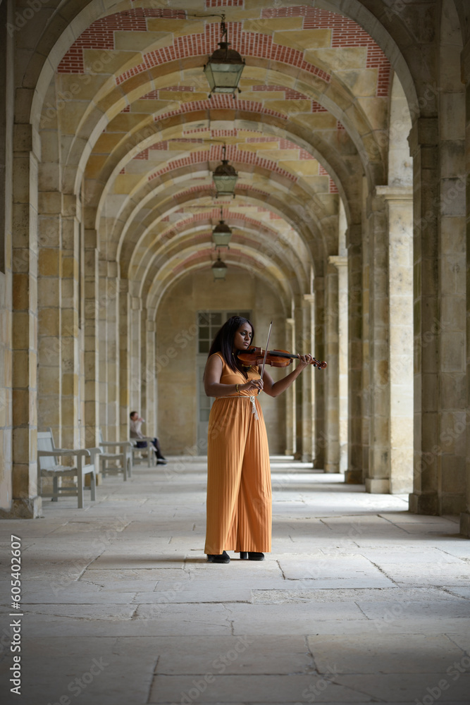 Lovely black woman playing violin in the street in Paris