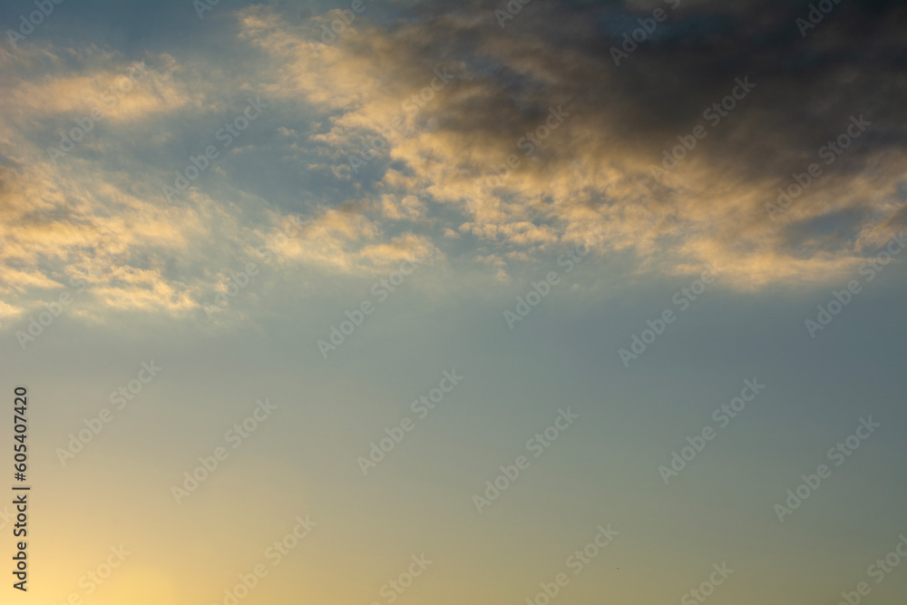 Fototapeta premium The setting sun illuminating the sky.