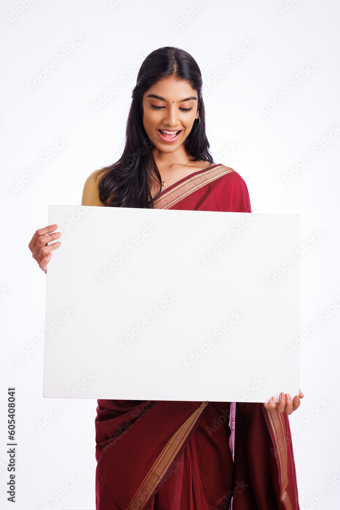Exited Indian woman in traditional saree holding sign board isolated on white. advertisement concept. Exited Indian woman in traditional saree holding sign board isolated on white. advertisement concept.