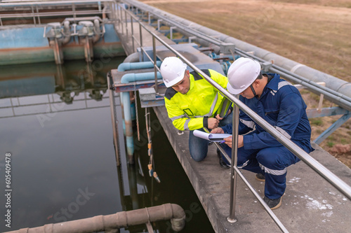 Environmental engineers work at wastewater treatment plants,Water supply engineering working at Water recycling plant for reuse,Technicians and engineers discuss work together.