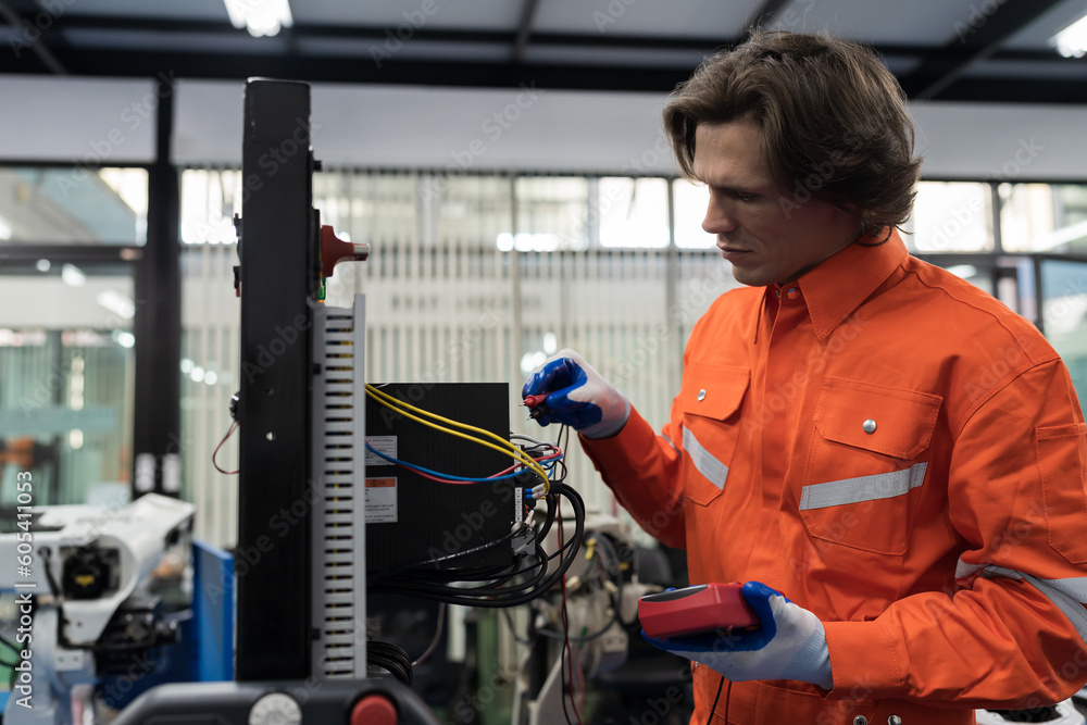 Male electrician worker checking, repair, maintenance operation electric system in building. Male electrician engineer using electrical meters working with operation electric system in control room