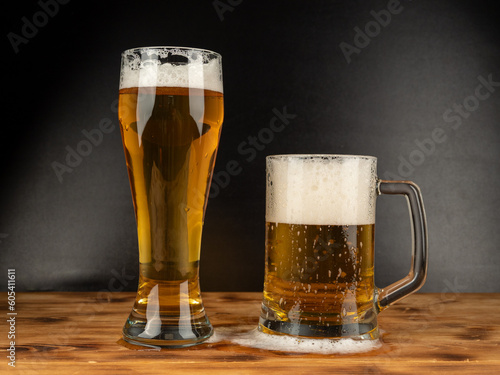 A glass of cold beer on a dark background. Glass of beer close-up.