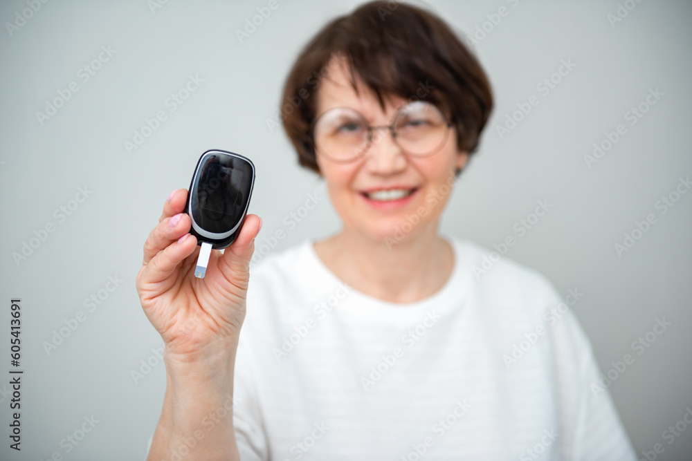Healthcare, diabetes and senior woman with glucometer checking blood sugar level on finger closeup. Health, innovation and medicine, daily life of diabetic with home test to check blood glucose levels Healthcare, diabetes and senior woman with glucometer checking blood sugar level on finger closeup. Health, innovation and medicine, daily life of diabetic with home test to check blood glucose levels