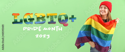 Beautiful young woman with LGBT flag on green background. Happy Pride Month