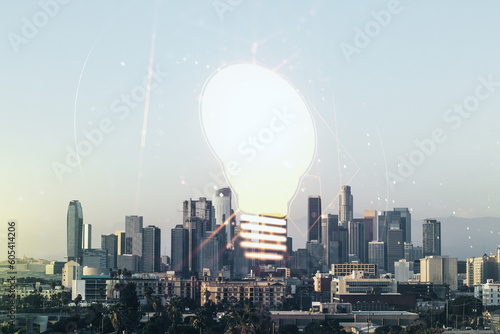Abstract virtual light bulb hologram on Los Angeles office buildings background, idea concept. Multiexposure
