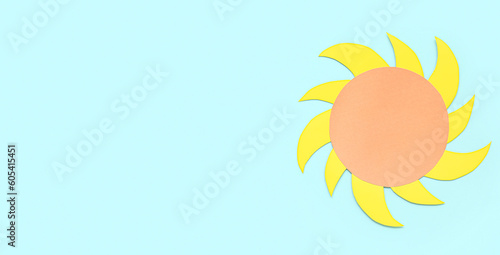 Sun made of paper on light blue background with space for text