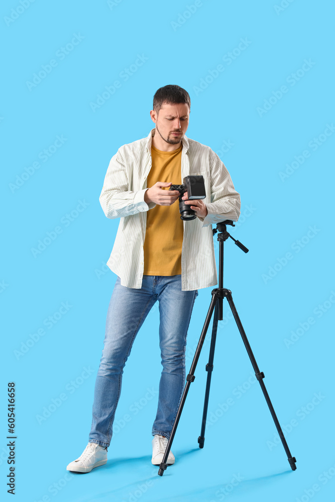 custom made wallpaper toronto digitalUpset male photographer with professional camera on blue background