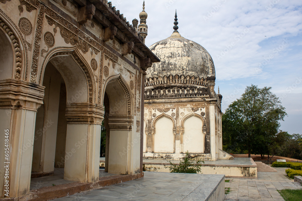 Historic tomb building with landscaped garden in Qutb Shahi Archaeological Park, Hyderabad, India