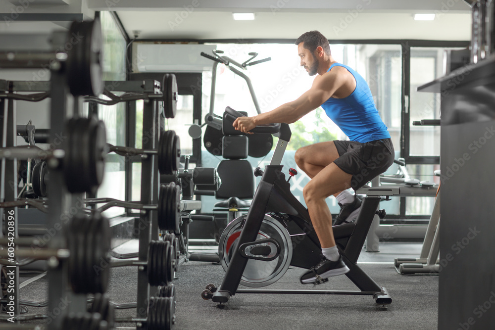 an cycling on a stationary bicycle at the gym an cycling on a stationary bicycle at the gym