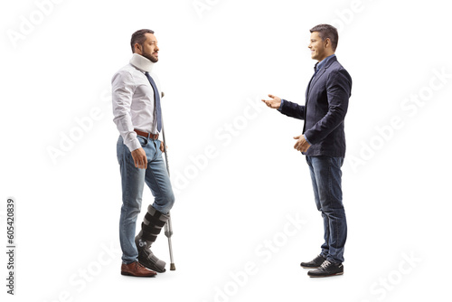 Full length profile shot of a man talking to an injured man with a walking brace and neck collar