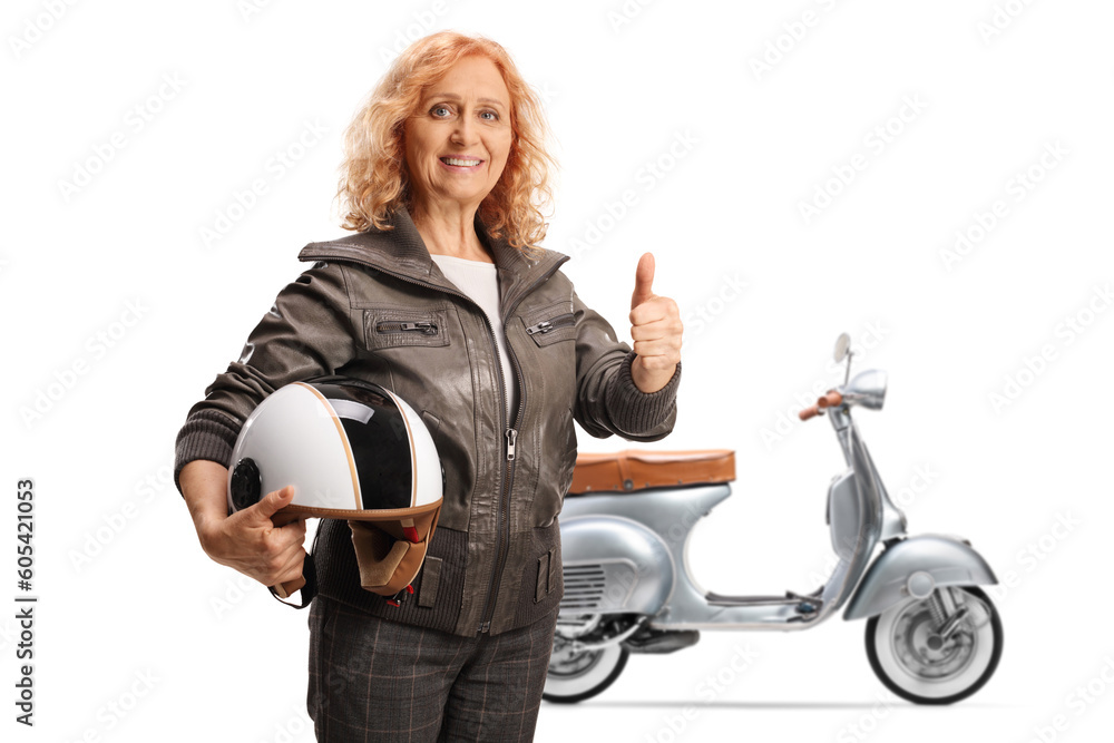 Mature woman with a scooter holding a helmet and gesturing thumbs up Mature woman with a scooter holding a helmet and gesturing thumbs up