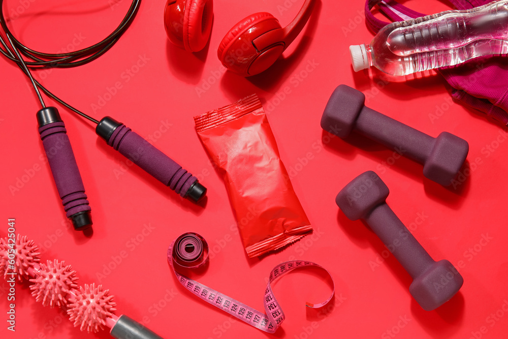 Healthy snack with sports equipment on red background - obrazy, fototapety, plakaty 