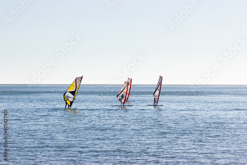 People learning windsurfing. Healthy lifestyle. Concept of sport, vacation and fun.