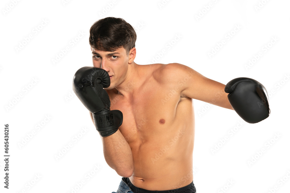 Young shirtless man with boxing gloves on a white background Young shirtless man with boxing gloves on a white background