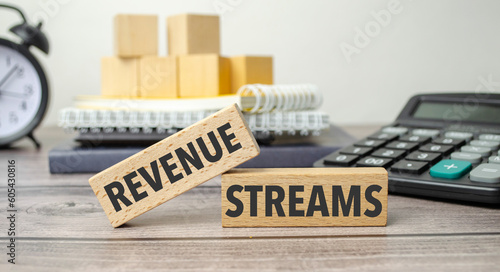 REVENUE STREAMS is shown on a conceptual photo using wooden blocks