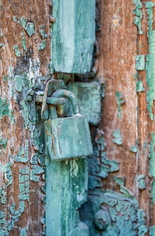 Old rusted padlock on a wooden door Old rusted padlock on a wooden door