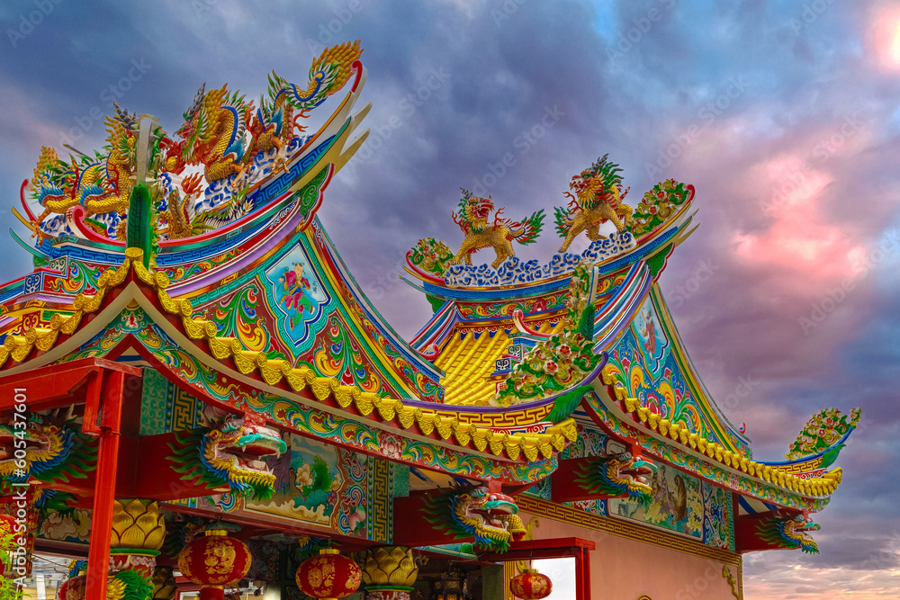 Colourful multicoloured dragon on top of a temple in Patong Phuket Thailand. beautiful blue green red of the scale dragons Colourful multicoloured dragon on top of a temple in Patong Phuket Thailand. beautiful blue green red of the scale dragons