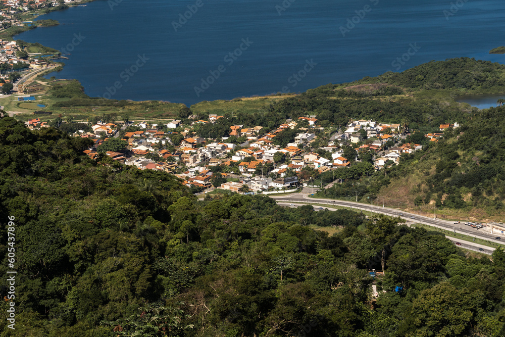 Beautiful view of Lagoa de Piratininga, with some houses in the middle of nature that border the banks of the lagoon in Niterói, Rio de Janeiro, Brazil. Sunny day
