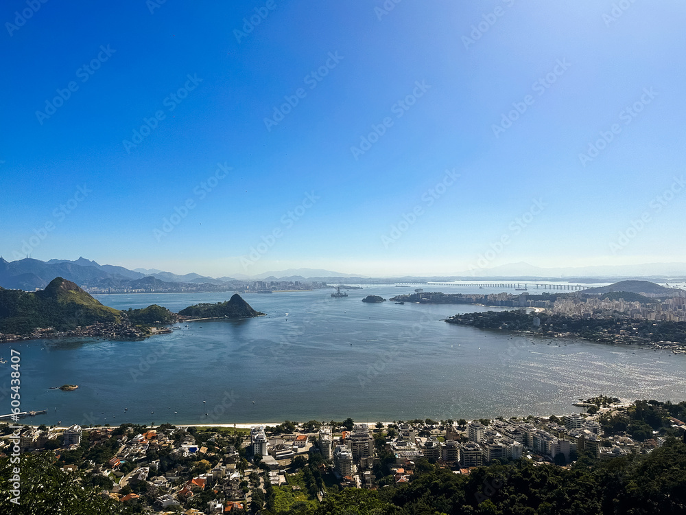 Beautiful view of Rio de Janeiro, Brazil seen from Niterói. With many hills in the background, Guanabara Bay, Jujuruba, Rio Niterói Bridge, Christ the Redeemer, beaches, pier with a boat. Sunny day Beautiful view of Rio de Janeiro, Brazil seen from Niterói. With many hills in the background, Guanabara Bay, Jujuruba, Rio Niterói Bridge, Christ the Redeemer, beaches, pier with a boat. Sunny day