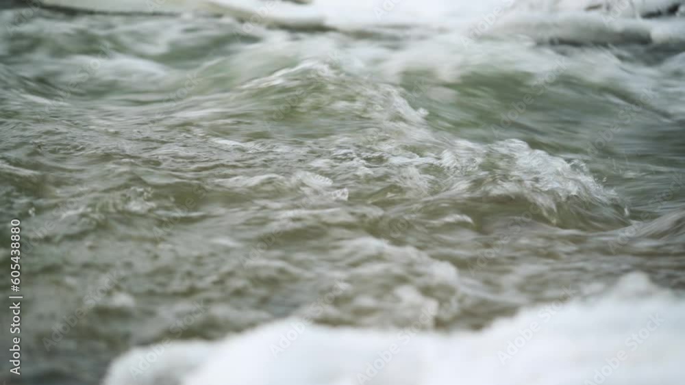 Winter river surface with snow crystals and ice floating on water - closeup detail Winter river surface with snow crystals and ice floating on water - closeup detail