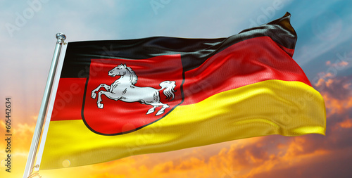 Lower Saxony Flag Waving in the Cloudy Sky at Sunset