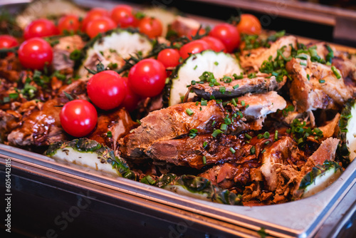 pork loin with vegetables, roast beef, served in a Brazilian restaurant or buffet, typical food for parties and social events, barbecues and celebrations.