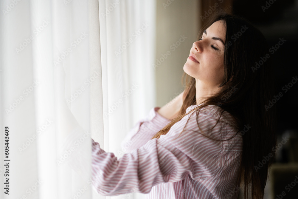 Young beautiful brunette woman relax with closed eyes at the window light background. Young beautiful brunette woman relax with closed eyes at the window light background.