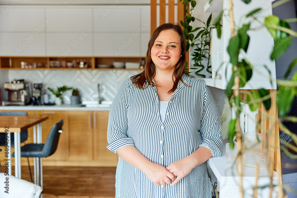 Portrait of a smiling plus-size woman dressed in a nice shirt at home. Portrait of a smiling plus-size woman dressed in a nice shirt at home.