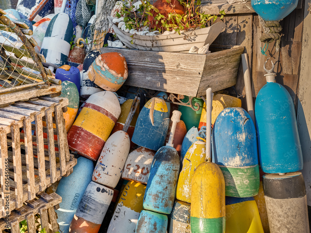 Fototapeta premium Old and retired colorful lobster floats and wooden lobster traps in Rockport Massachusetts