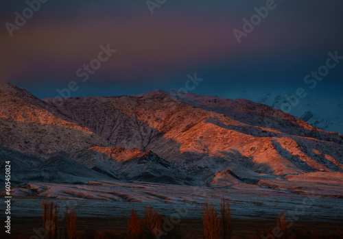 Picturesque mountain winter landscape at red sunset light
