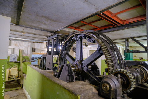 Very large gears. Smeared with oil. Cable car lifting devices