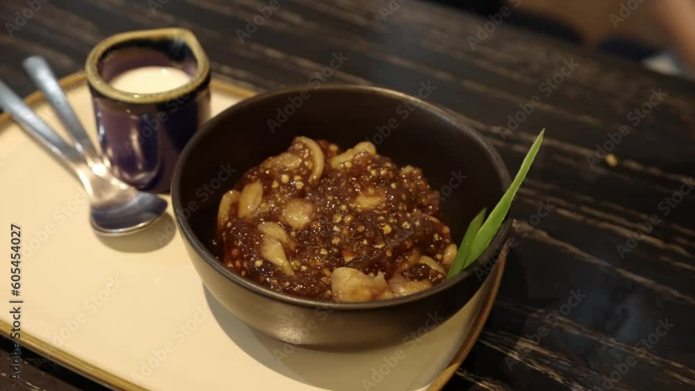 4k video, Sago pearl with longan, young coconut and coconut milk. Popular dessert in Thailand served with fresh coconut milk. Sago palms with coconuts or sago pearls in coconut milk on the table. 4k video, Sago pearl with longan, young coconut and coconut milk. Popular dessert in Thailand served with fresh coconut milk. Sago palms with coconuts or sago pearls in coconut milk on the table.
