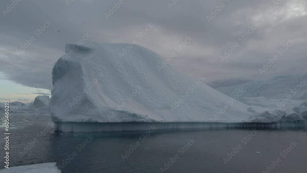 Sailing past massive icebergs in Greenland's Disko Bay Sailing past massive icebergs in Greenland's Disko Bay