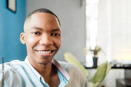 Man with a perfect white smile looking at the camera at home