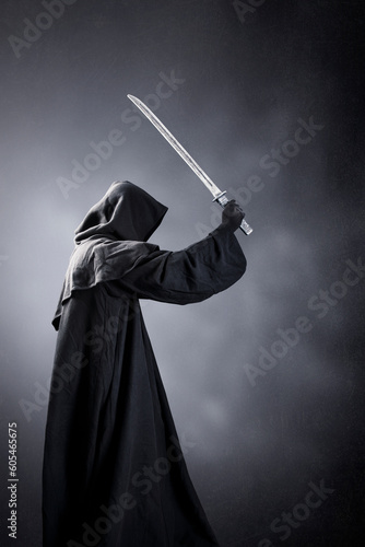 Samurai warrior with katana sword over dark misty background photo