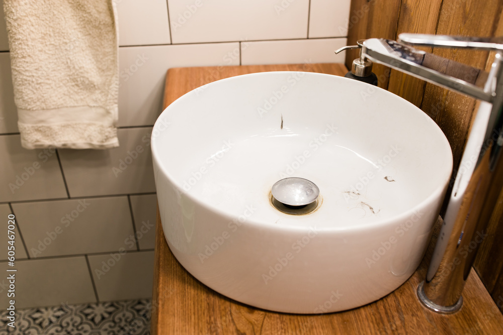 Fototapeta premium Water tap with dirty sink close up. chrome faucet wash basin. Hygiene and Cleaning hands and messy home concept.