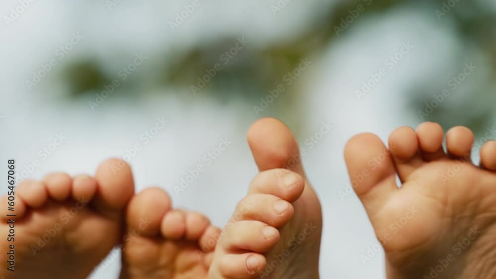 Feet of children, which swinging on hammock at summer.Kids relax,happy childhood Feet of children, which swinging on hammock at summer.Kids relax,happy childhood