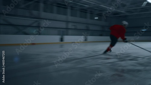 High-intensity ice hockey rink arena with a skilled player demonstrating impressive speed and accuracy by shooting, hitting, and striking the puck with hockey sticks. Athlete scoring a goal cinematic  photo