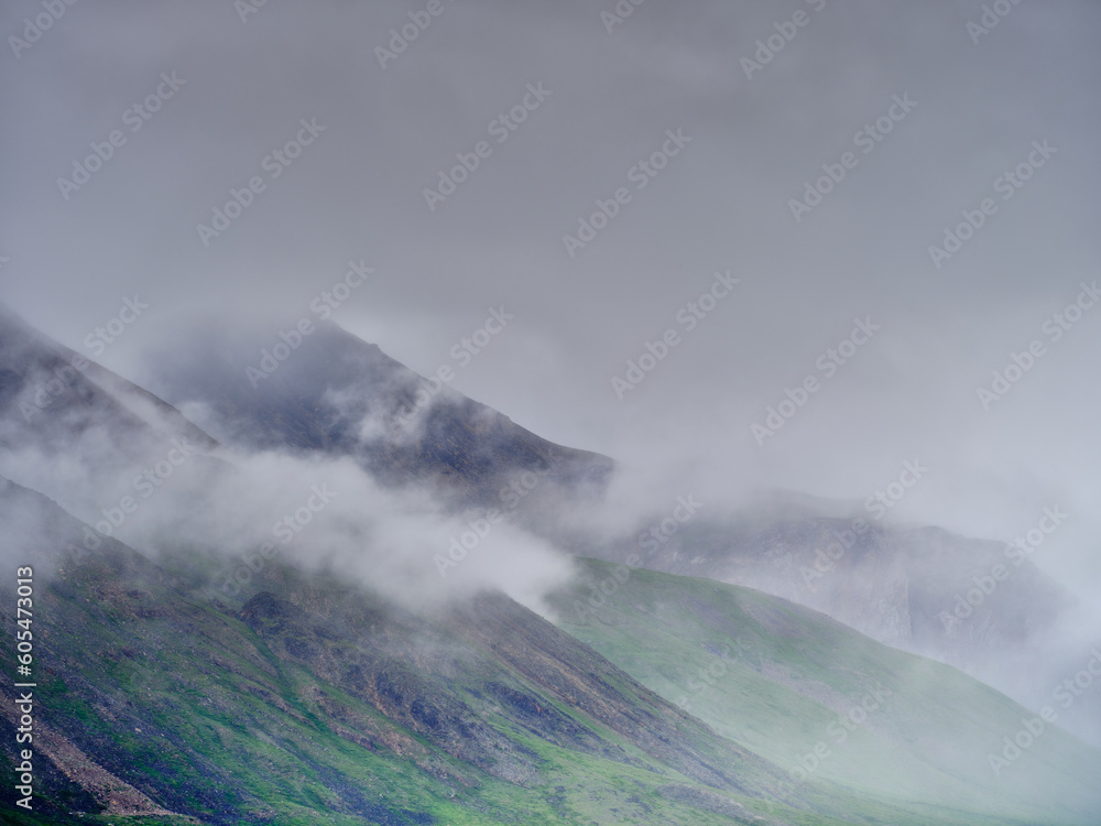 Mist and fog rolls down the mountain slopes along the wild and desolate Dalton Highway on the way to Deadhorse and Prudhoe Bay near the village of Nuiqsut in the North Slope Borough
