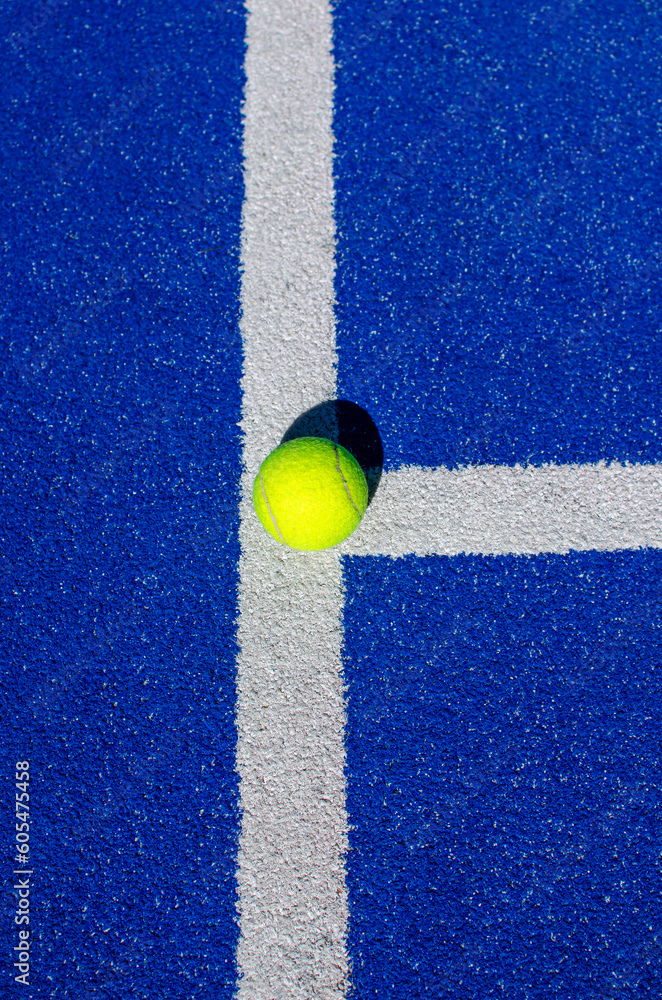 ball on a blue paddle tennis court