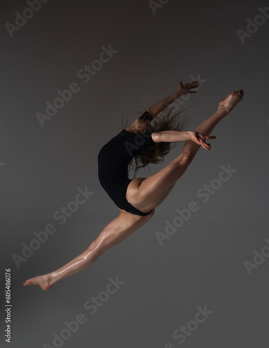 Leg-split jump. Flexible woman. Fit girl stretching and dancing. Stretching sexy flexible body. Flexible woman gymnast. Inspiration. Graceful ballet dancer. Art, motion, flexibility concept.