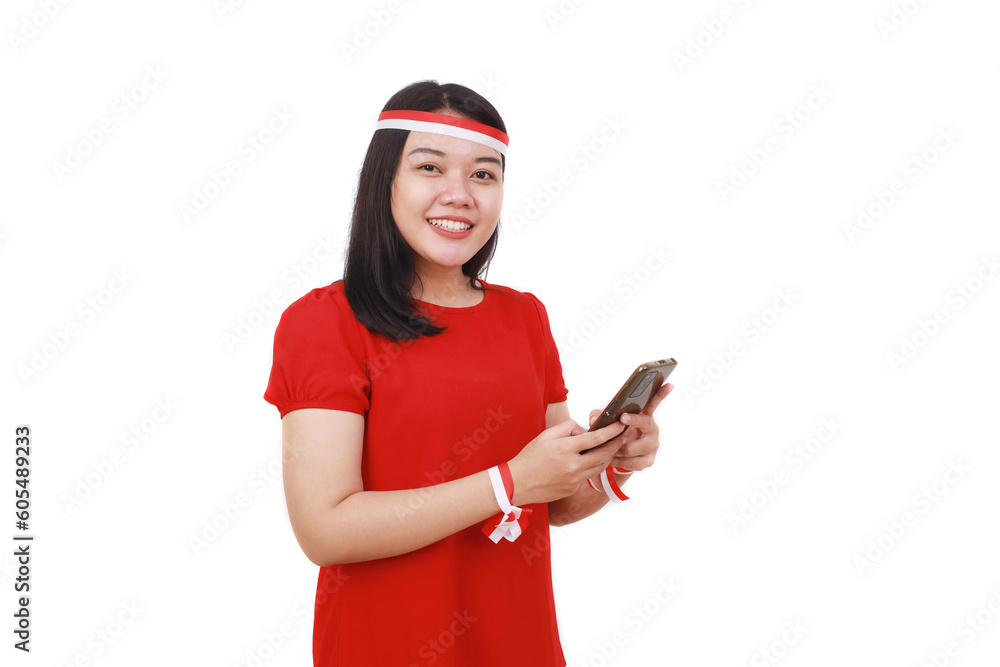 Young indonesian girl celebrate independence day while holding cell phone. Isolated on white Young indonesian girl celebrate independence day while holding cell phone. Isolated on white