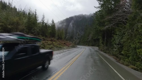 Scenic Road in Canadian Nature from Port Alberni to Tofino. Pacific Rim Hwy, Vancouver Island, British Columbia, Canada. Cloudy Rainy Day photo