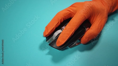 Wallpaper Mural person in gloves uses wireless mouse on azure background Torontodigital.ca